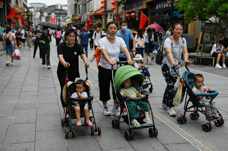 2021年7月13日，3名婦女在1處北京商業街推娃娃車逛街。（法新社檔案照）